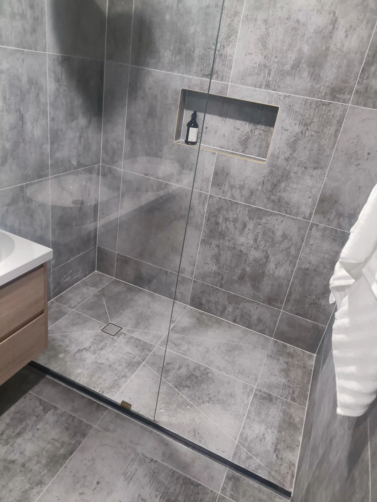 Grey concrete-look tiled shower with clean silicone seals, Melbourne bathroom