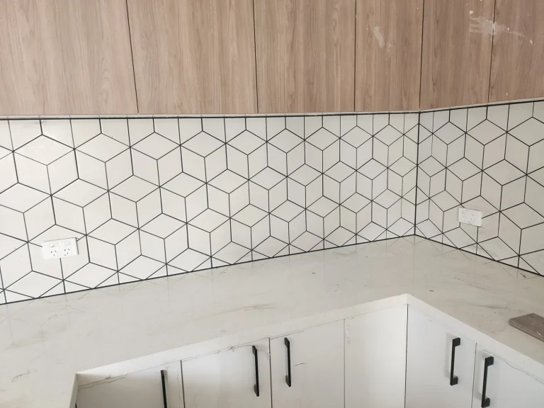 White geometric tiled kitchen splashback with clean caulked joints, Melbourne